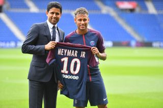 Neymar and club president Nasser Al-Khelaifi pose with Neymar's number 10 PSG shirt following his world-record transfer from Barcelona, August 2017