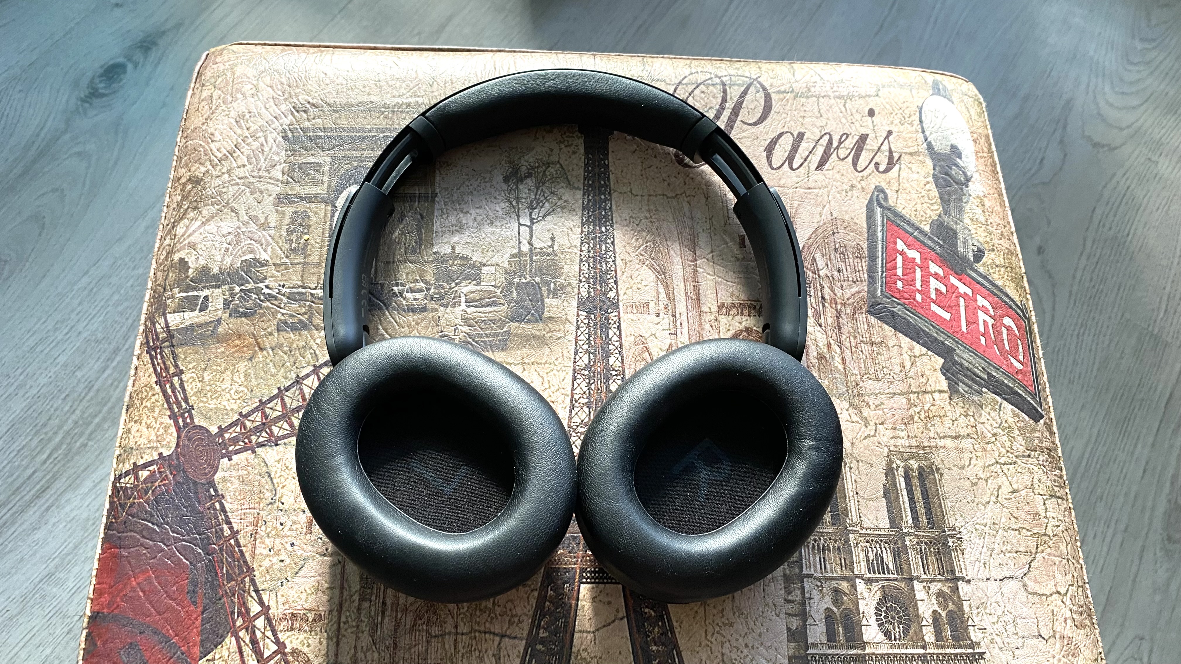 Inner earcups of the OneOdio Focus A6 over-ear headphones on a Parisian stool