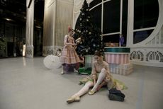 A ballet dancer puts on her shoes while sitting on a stage behind the curtain before Nacho Duato's "The Nutcracker" at the Mikhailovsky Theatre in St. Petersburg, Russia.