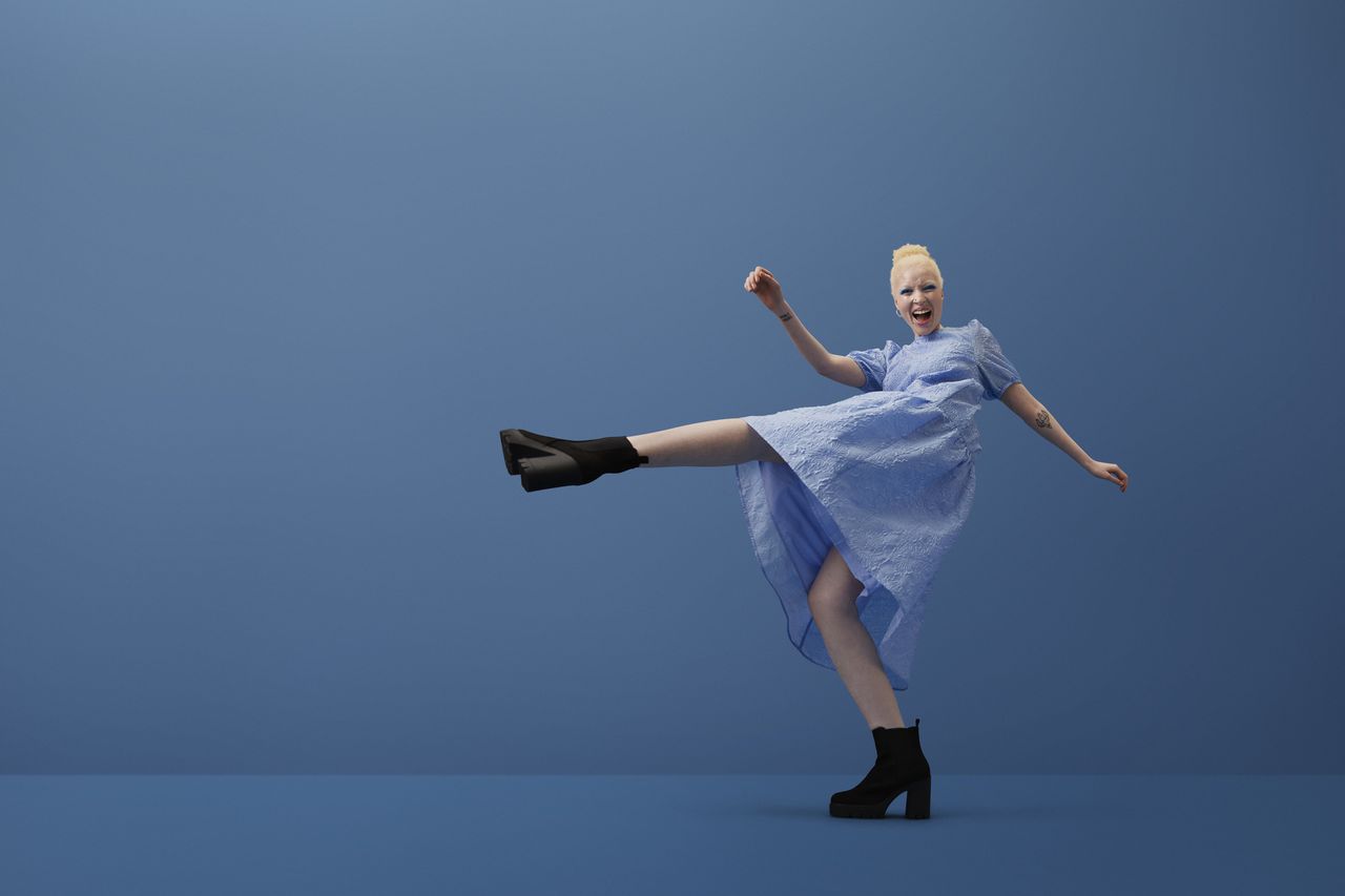 Woman in a blue dress with boots