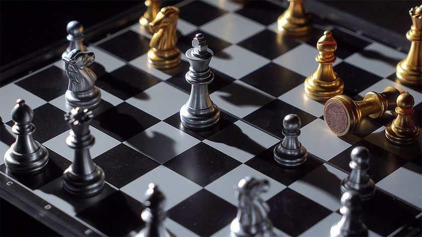 Silver and gold chess pieces on a chess board