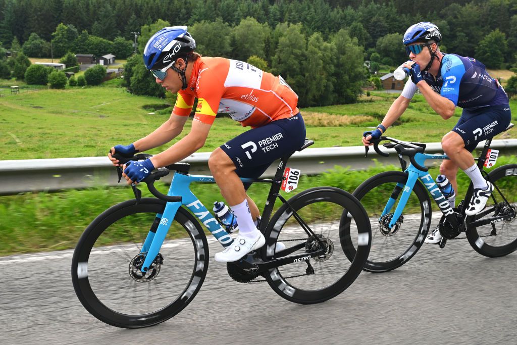 LA ROCHEENARDENNE BELGIUM JULY 24 LR Corbin John Strong of New Zealand Orange Leader Jersey and Simon Clarke of Australia and Team Israel Premier Tech compete during the 45th Tour de Wallonie 2024 Stage 3 a 19263km stage from Arlon to La RocheenArdenne on July 24 2024 in La RocheenArdenne Belgium Photo by Luc ClaessenGetty Images