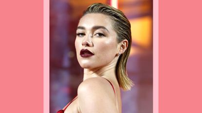 Florence Pugh wearing a red satin dress, with her hair slicked back and wearing dark, plum-colored lipstick as she attends The Fashion Awards 2022 at the Royal Albert Hall on December 05, 2022 in London, England./ in a pink and peach template