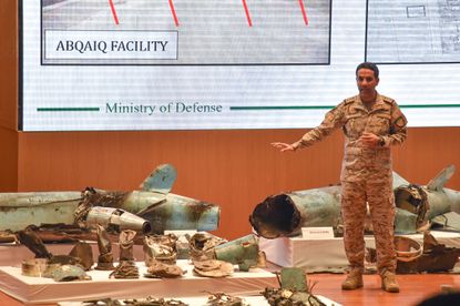TOPSHOT - Saudi defence ministry spokesman Colonel Turki bin Saleh al-Malki displays pieces of what he said were Iranian cruise missiles and drones recovered from the attack site that targete