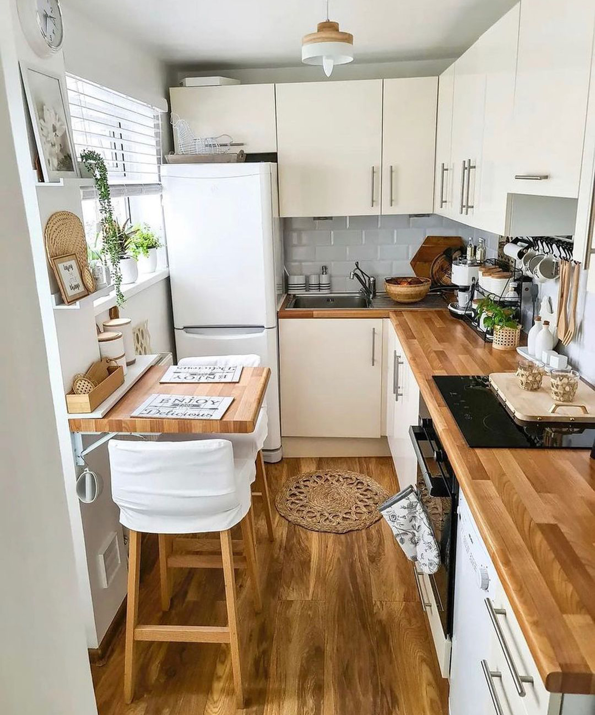 A dining area in small kitchen with drop-leaf wooden table and bar stool combo