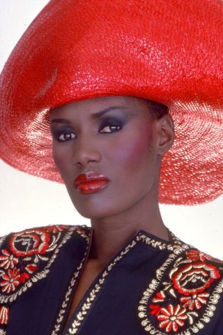 Grace Jones with bold eyeshadow and a red lip