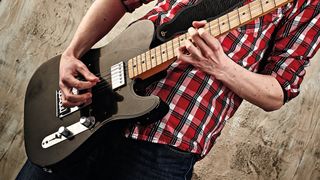 Man playing Fender Telecaster electric guitar