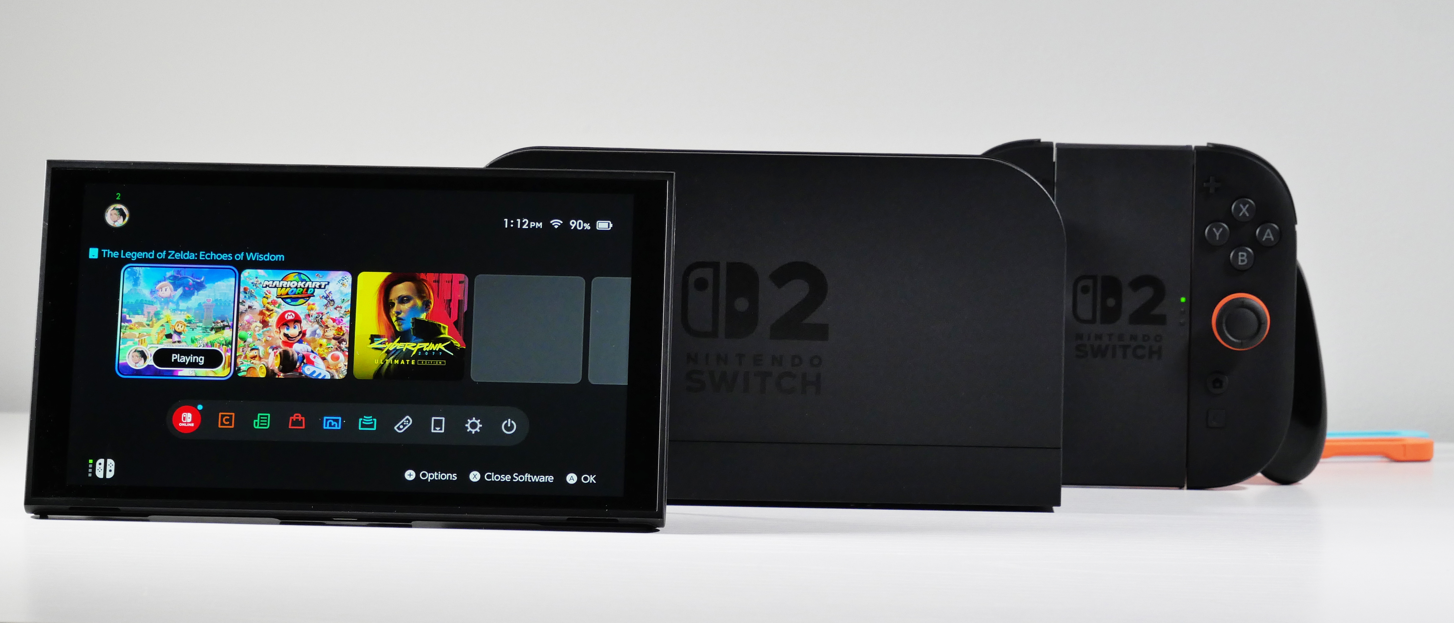 Nintendo Switch 2, Dock, Joy-Con 2 Grip, and Straps displayed on a white desk.