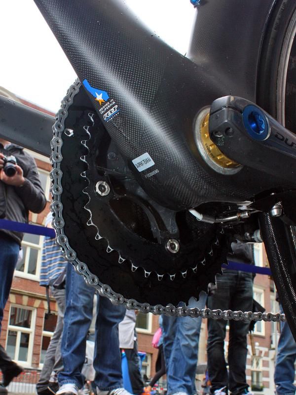 The custom carbon fiber cap covering David Millar's (Garmin-Transitions) O.symetric chainrings is purely for aerodynamics and cosmetics as it is only attached by the chainring bolts and does little to stiffen the ring itself.