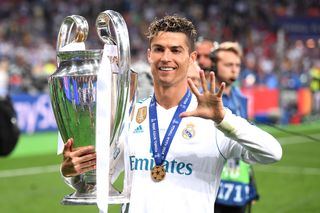 Real Madrid forward Cristiano Ronaldo poses with the Champions League trophy in 2018 after winning the competition for a fifth time.