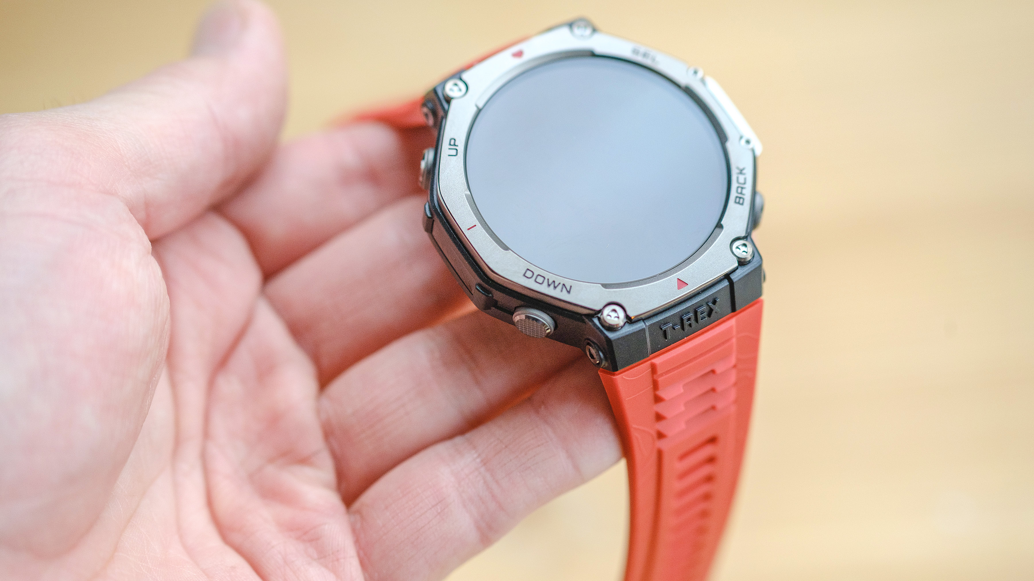 Close up of the Amazfit T-Rex 3 smartwatch on an orange silicone strap