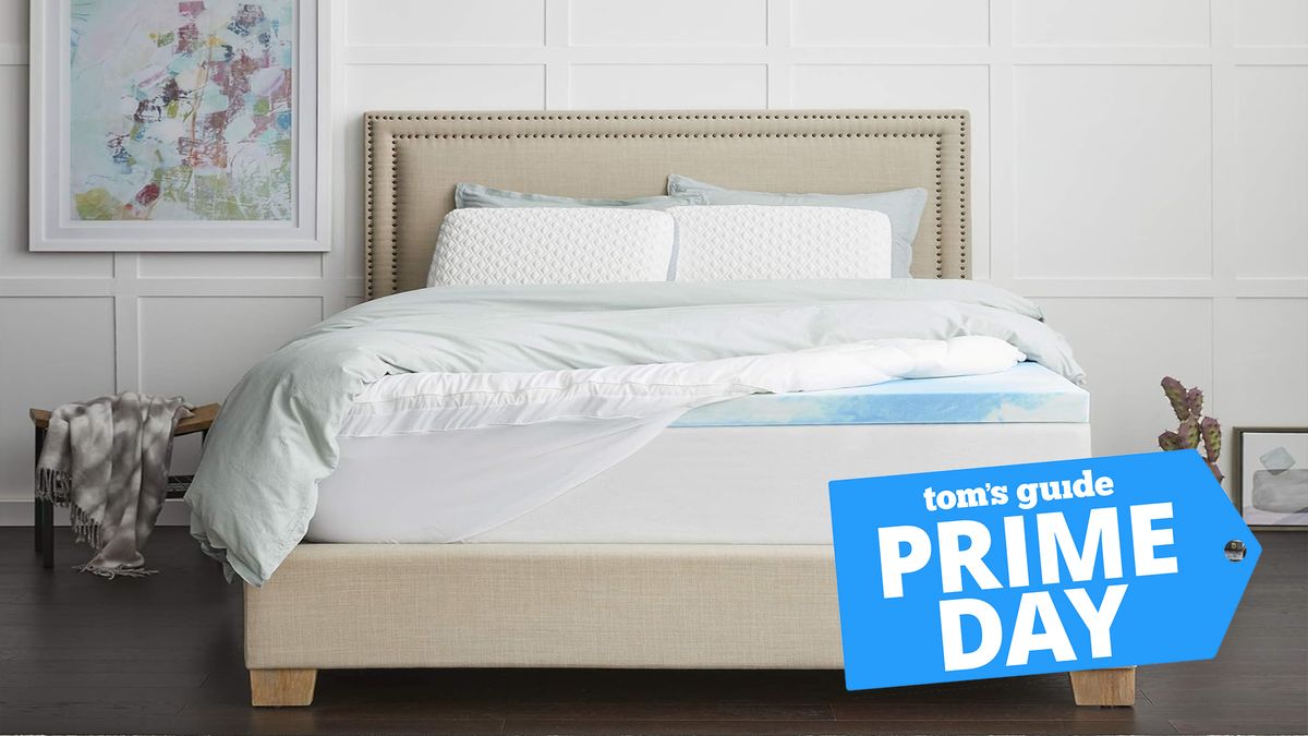 Prime Day cooling mattress toppers guide image shows the Sealy 4 Inch Gel Cooling Mattress Topper placed on a white mattress in a white bedroom during summer