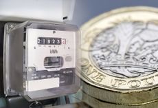The Ofgem energy price cap resembled by a meter with GBP pound coins stacked nearby