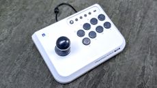 Hori Fight Stick Mini placed on pavement