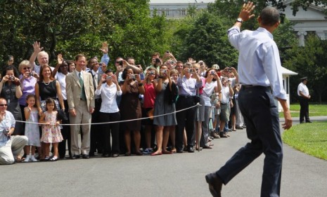 President Barack Obama waves at a crowd as he departs on a vacation to Martha's Vineyard, Massachusetts. The First Family will return to Washington on August 29.