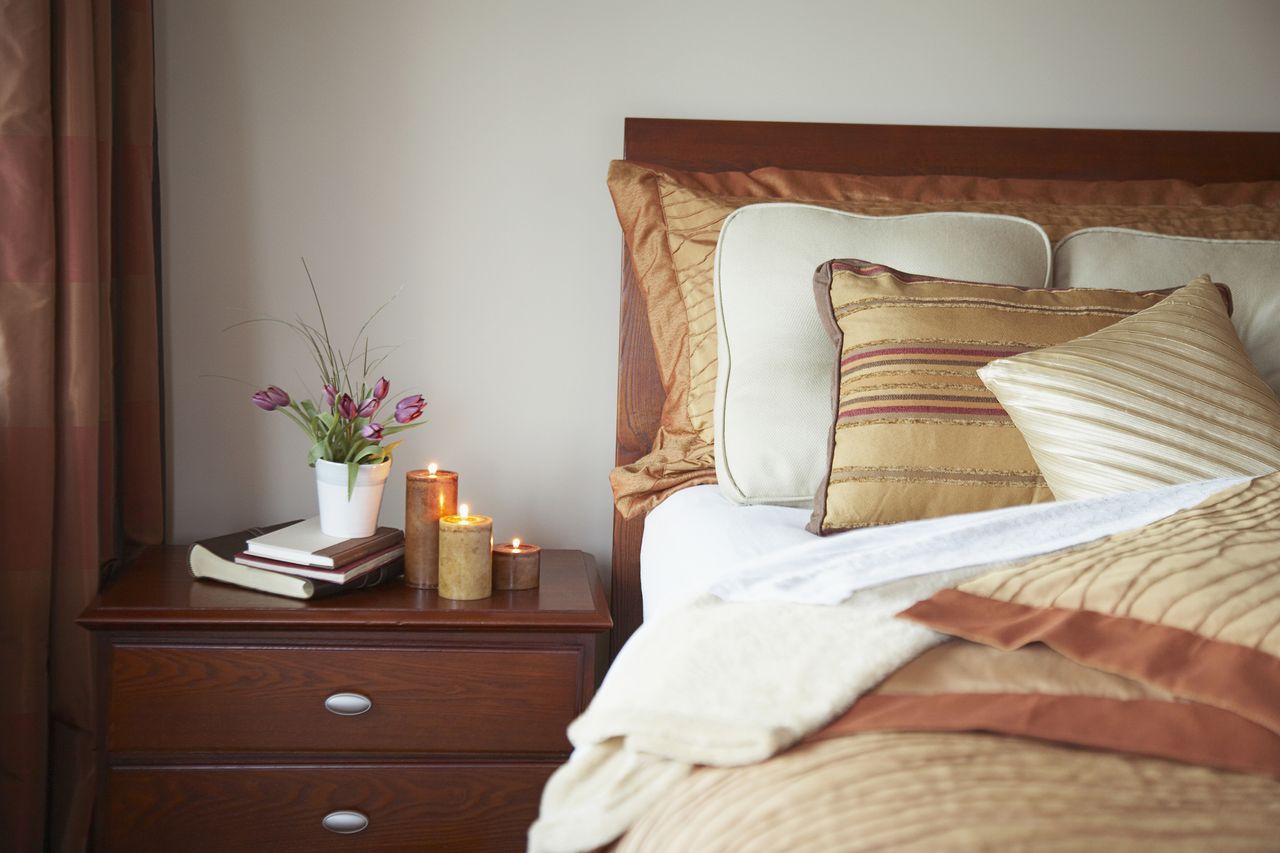 Bedroom with a bed with a stack of pillows