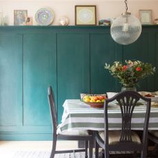 dining room with green painted wall panelling