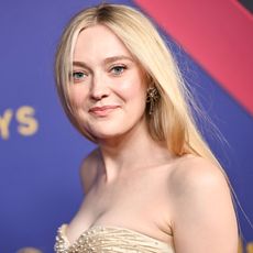 Dakota Fanning wears a strapless champagne gown by Armani Privé on the 2024 Emmys red carpet