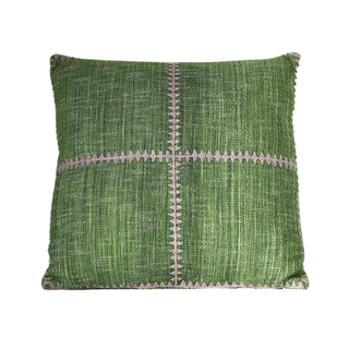 A green throw pillow with purple trim