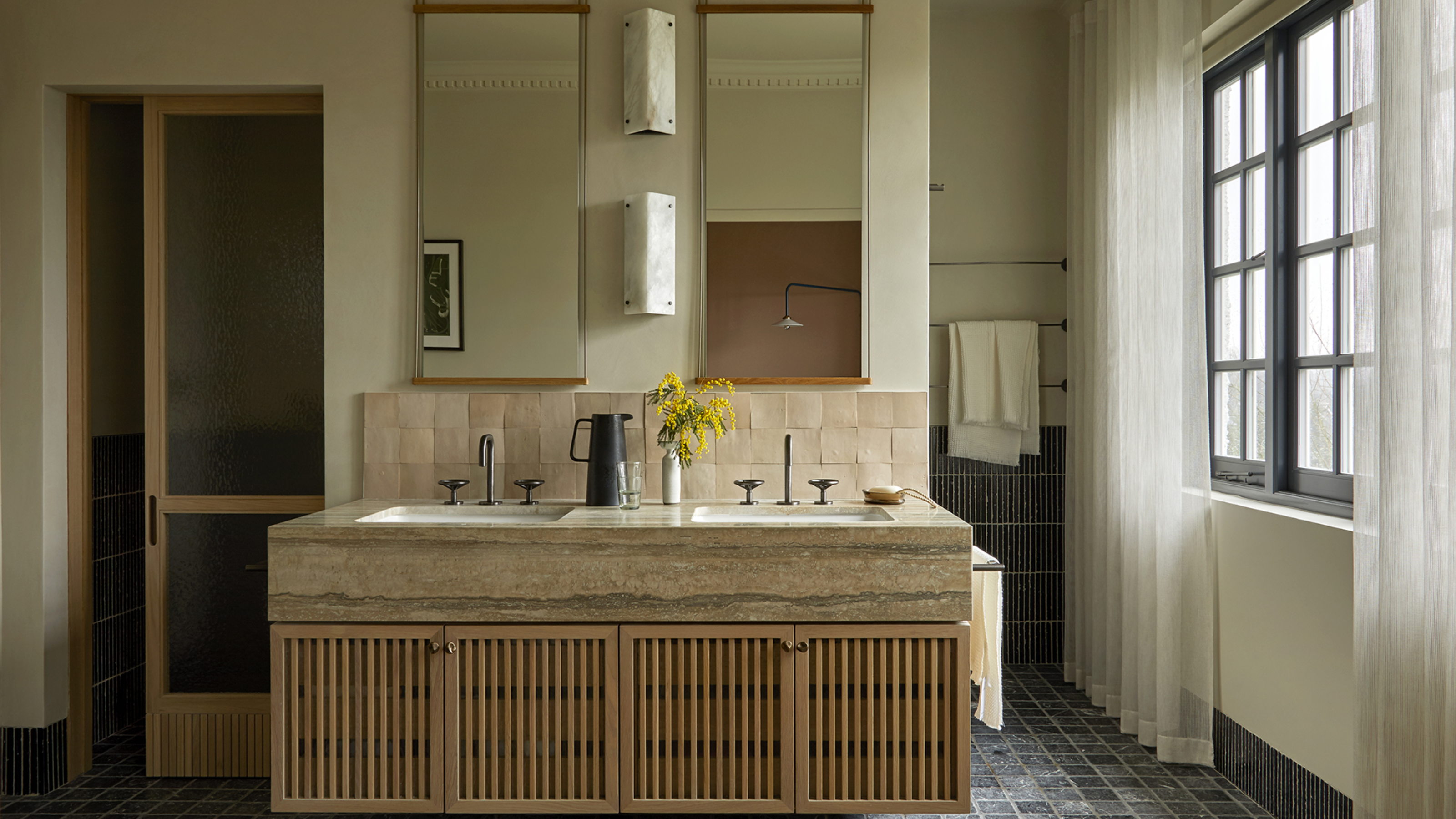 large bathroom with double vanity and two mirrors above it