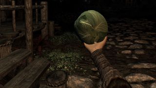A cabbage being held in an armored hand in a modded game of Skyrim VR.