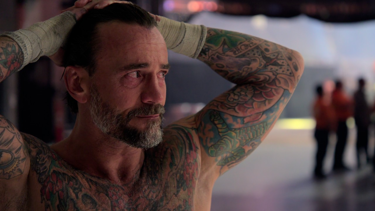 CM Punk with his hands on his head looking upset