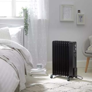 black space heater in white bedroom