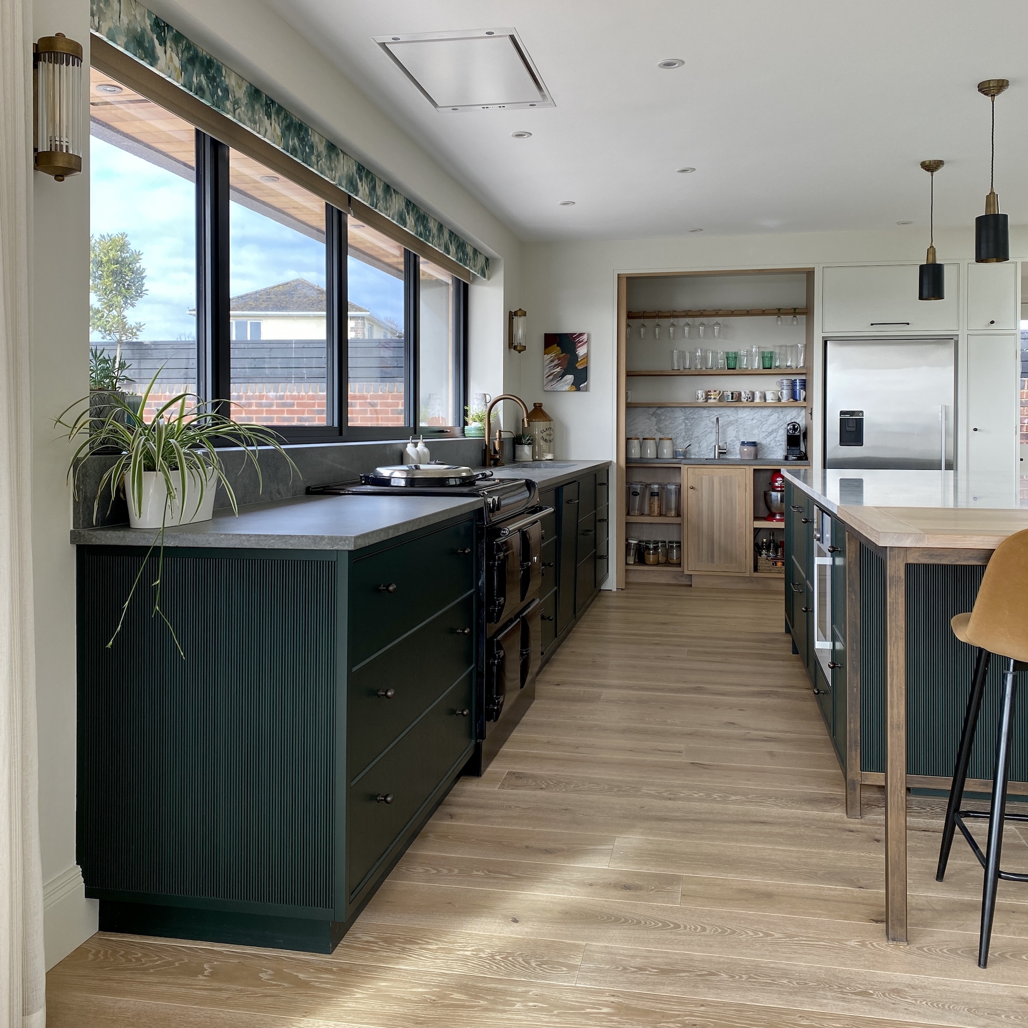 green kitchen with wood flooring