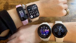 a photo of the apple watch 9, google pixel watch 2, fitbit inspire 3 and garmin forerunner 265