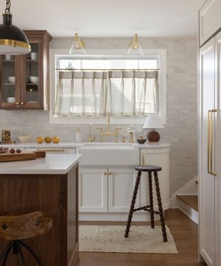 White vintage kitchen with wooden island and white cabinetry