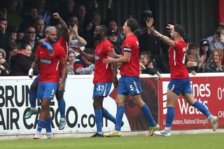 Dagenham & Redbridge players celebrate a goal against Wrexham in May 2022.