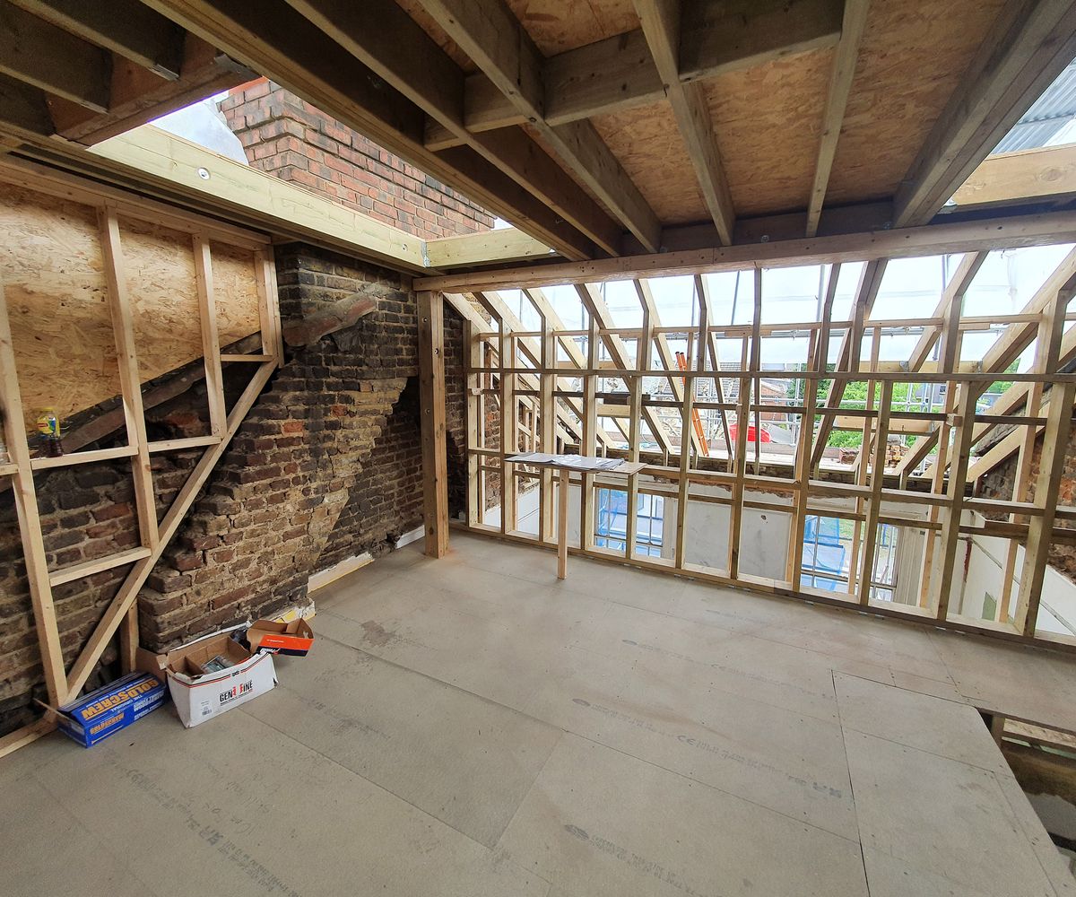 The interior of a loft conversion with many roof joists