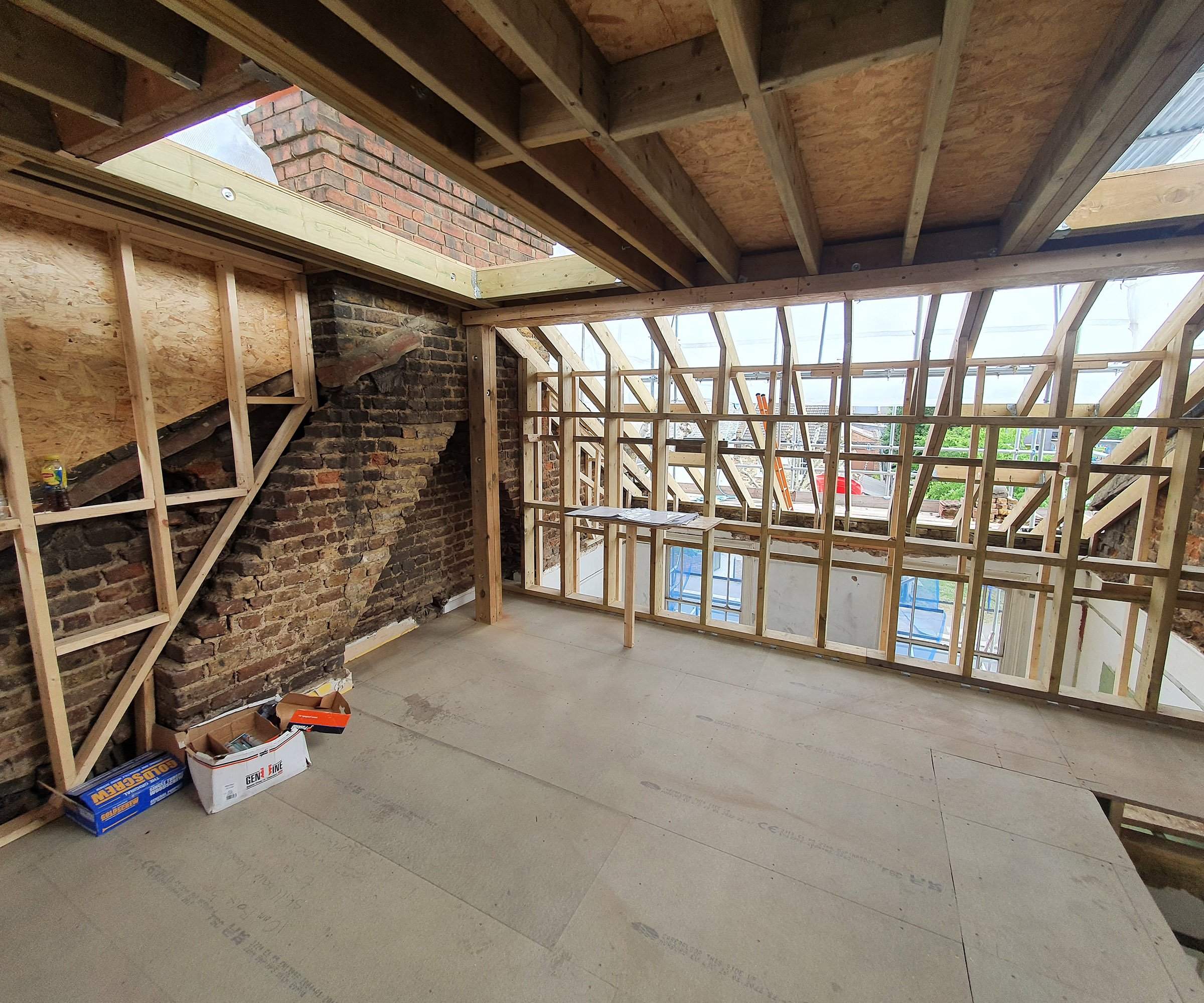 The interior of a loft conversion with many roof joists