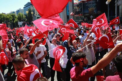 People wave Turkish flags after a failed coup