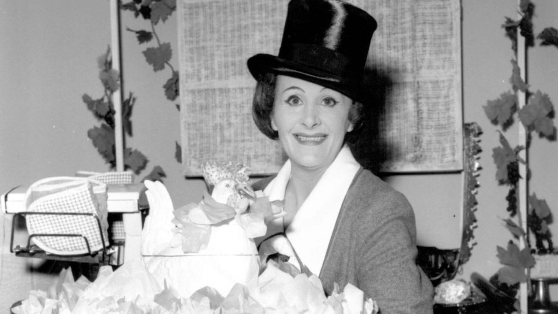 A black and white image of Fanny Cradock in a top hat