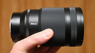 Nikon Z 35mm f/1.2 S product shot with lens held in hand