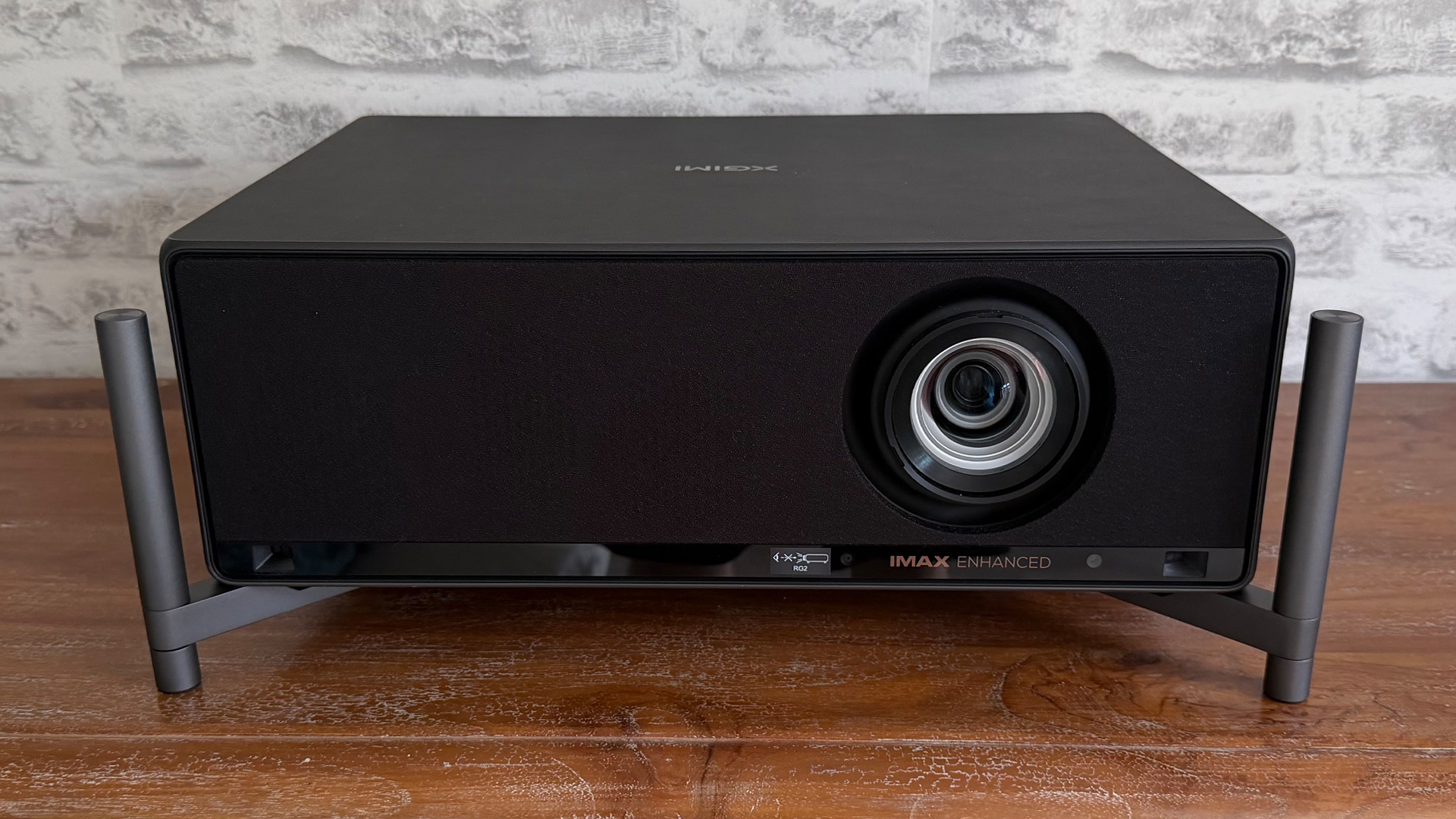 Xgimi Titan home cinema projector on wooden surface with legs attached