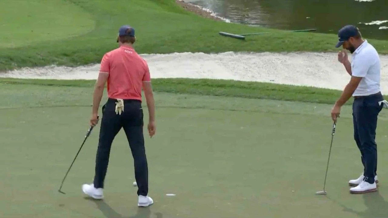 Thomas Detry stands over a putt as Stephen Jaeger watches on