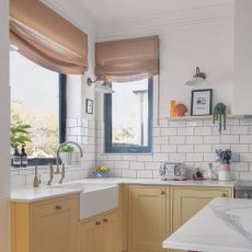 Yellow kitchen with draped blinds