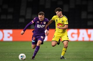 Kristian Popovic of Perth Glory and Liberato Cacace of Wellington Phoenix compete for the ball during a 2020 A-League match