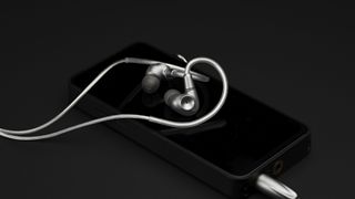 Meze Astru wired in-ear headphones in silver on a smartphone