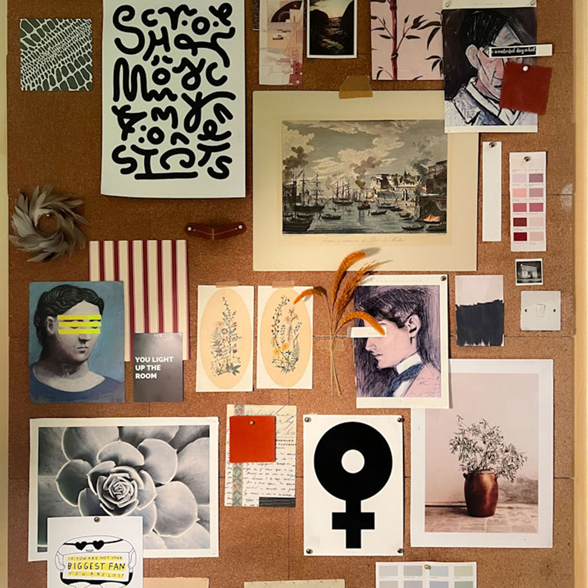 Cork pinboard filled with artwork and notes