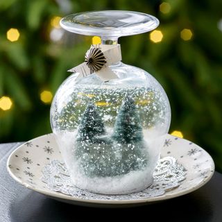 small christmas tree on plate and reverse glass over it