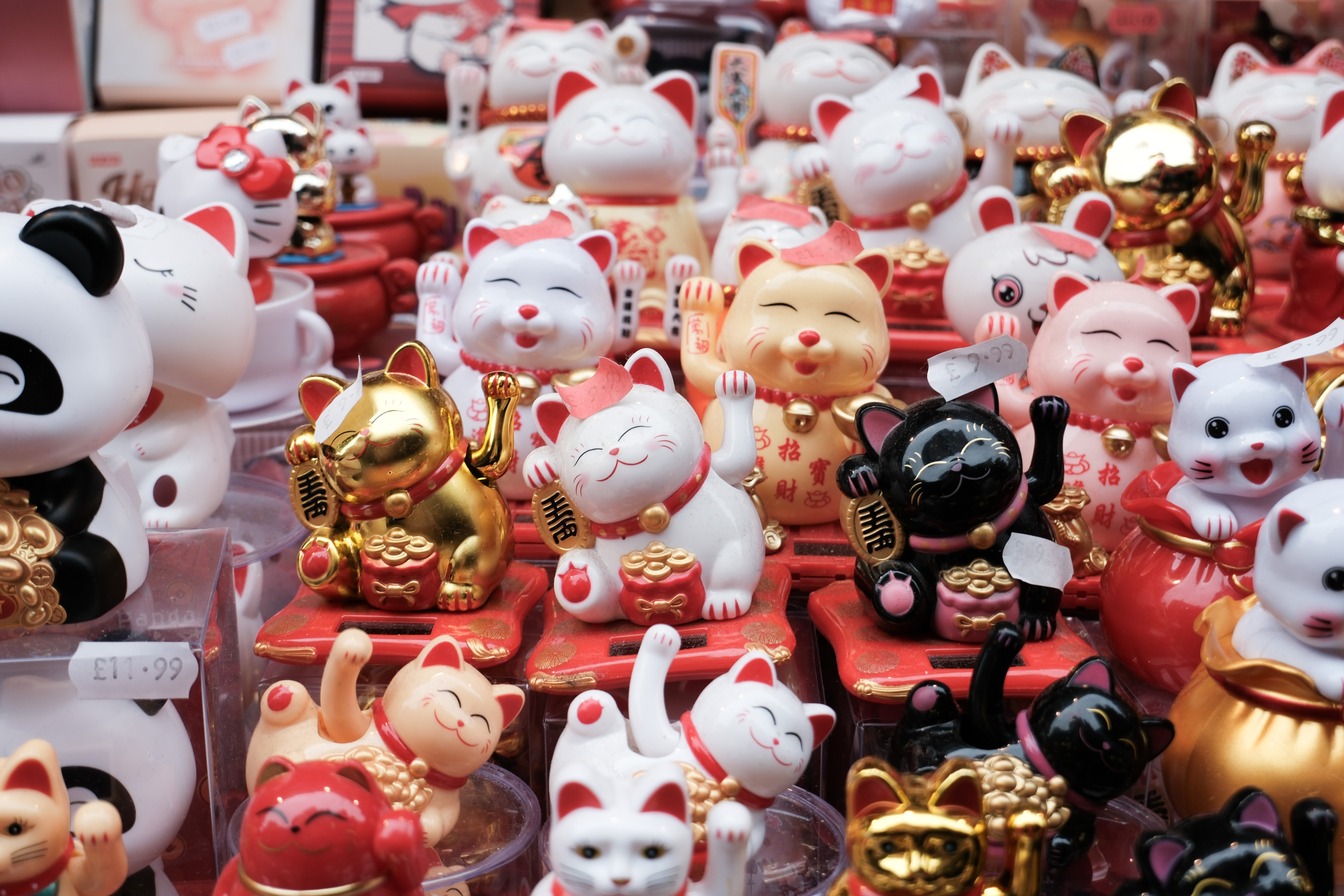Chinese lucky cat toys lined up on a stall selling them