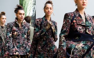 Chanel: Models wear matching patterned suits in black and pink