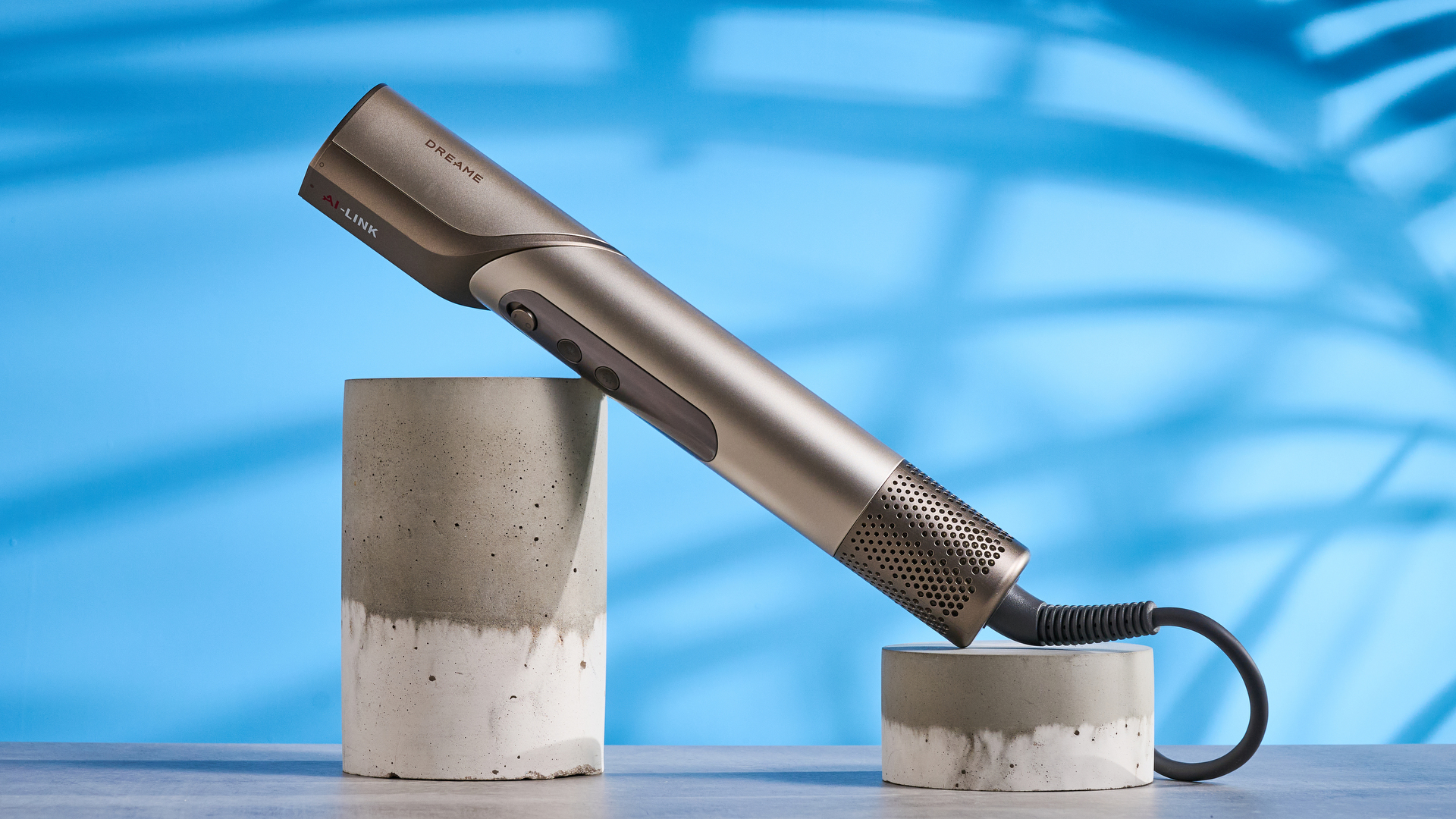 Dreame Dazzle air styler photographed in front of a blue background