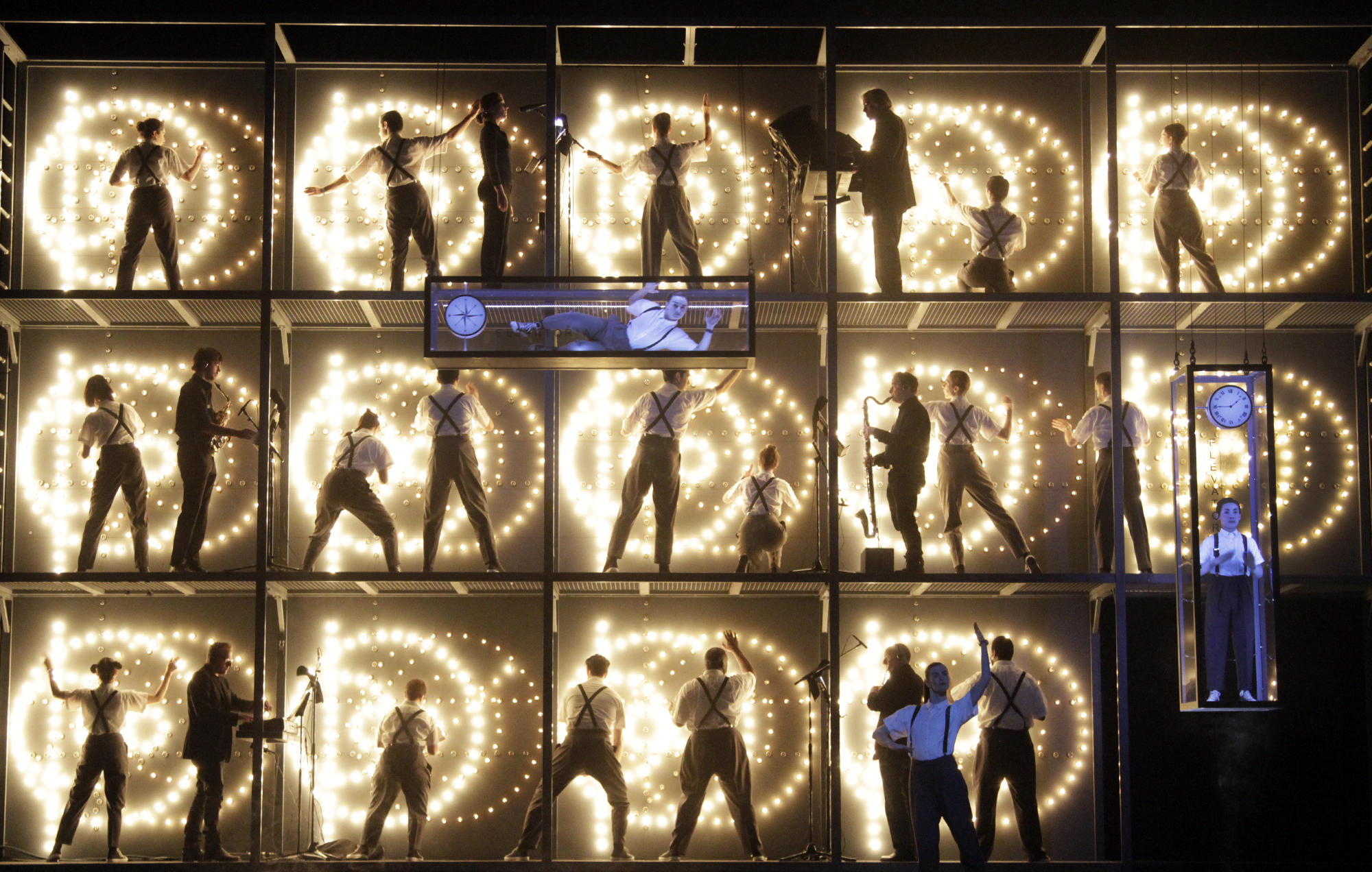 a grid of people and light on stage