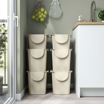 6 IKEA TRÖSKNING Bins stacked on top of each other in a kitchen.