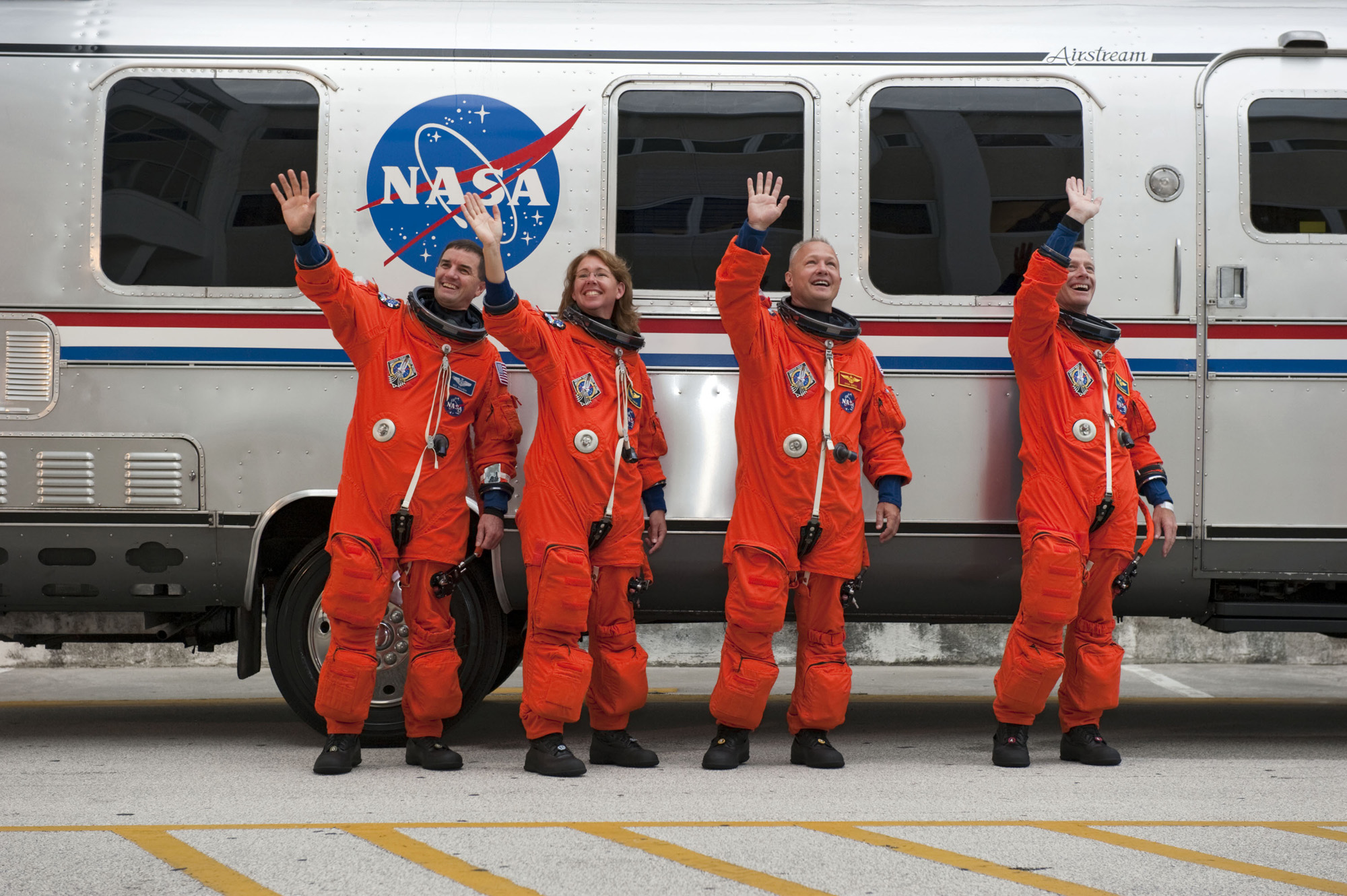 Last shuttle astronauts wave goodbye.