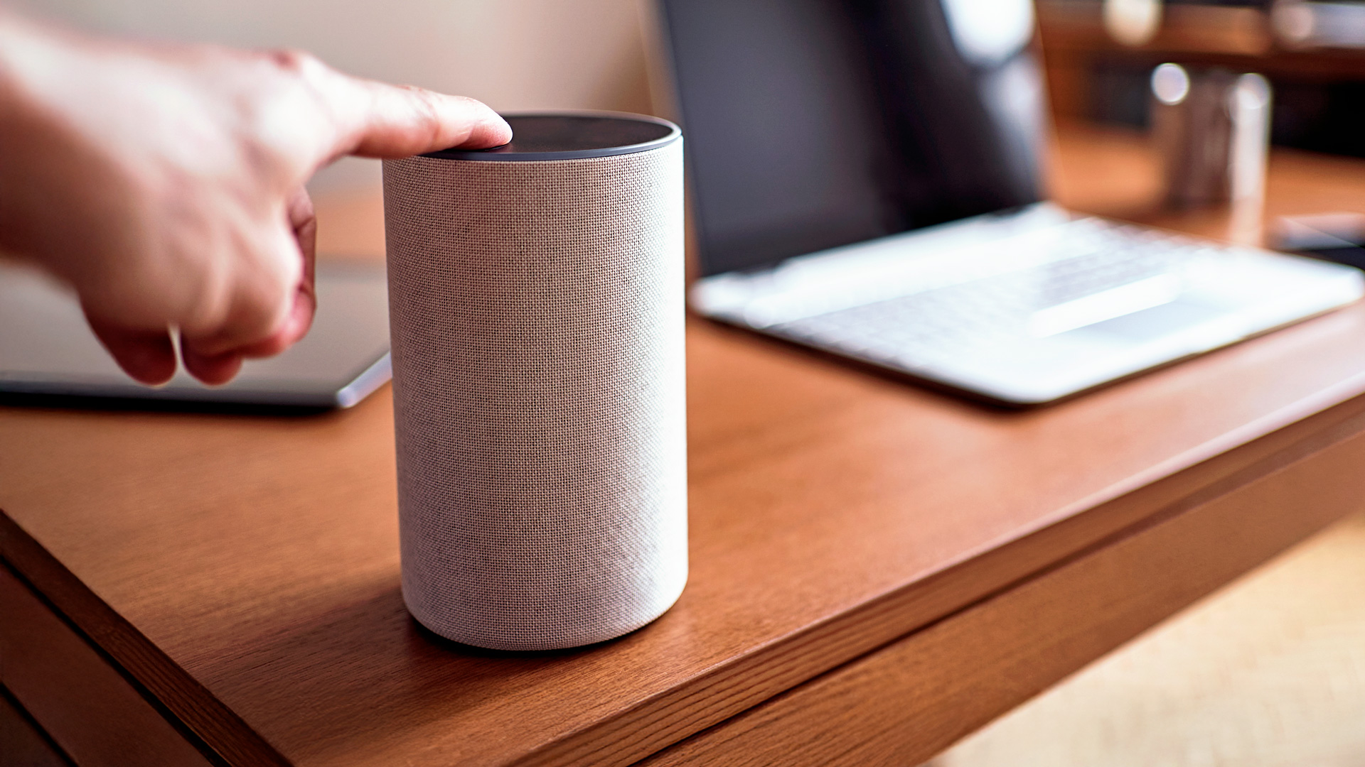 Someone pressing the on button of their EE speaker